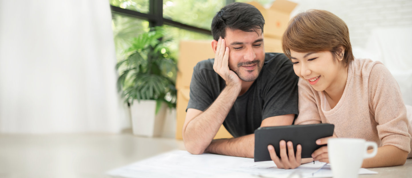 Couple looking at a tablet.